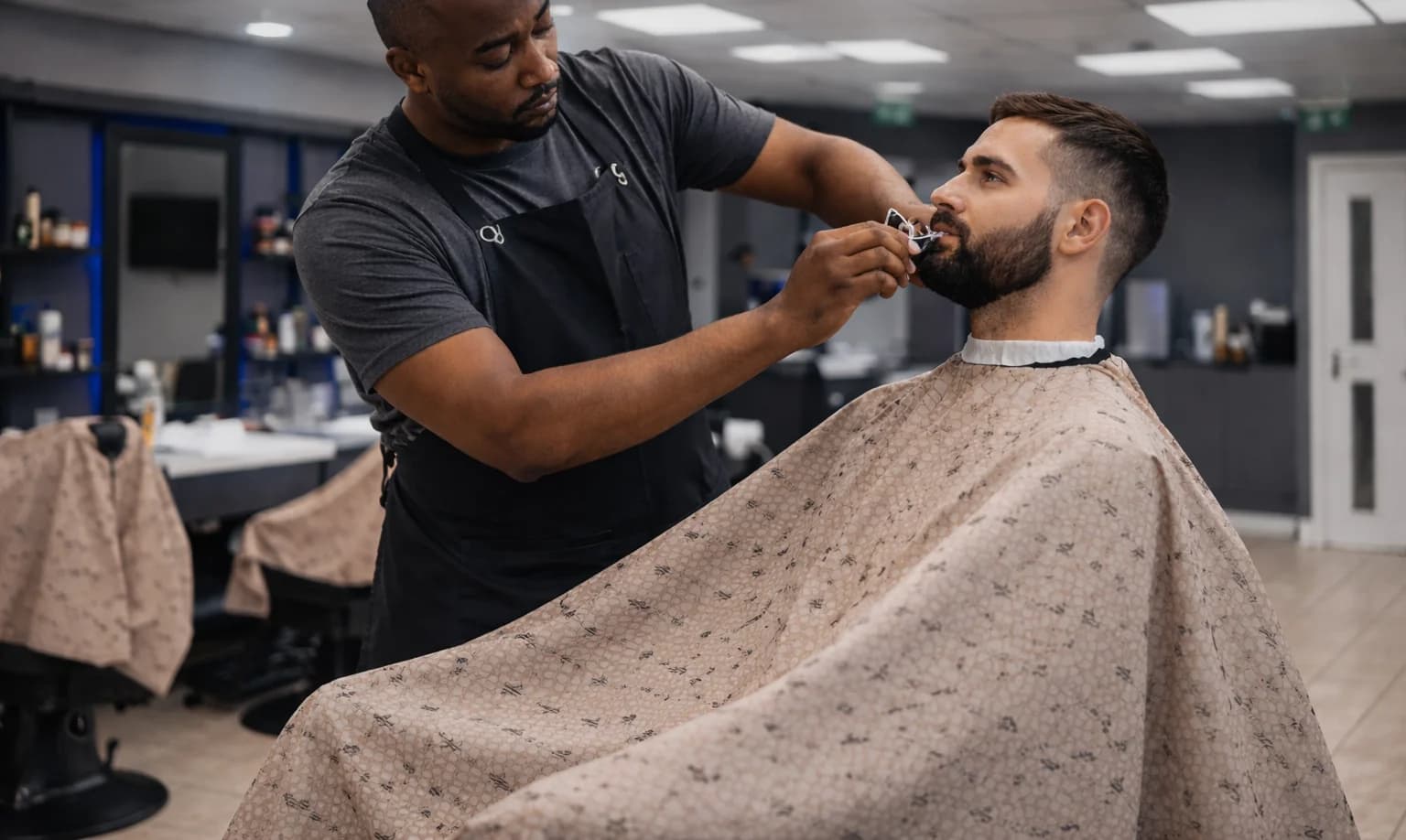 Barber grooming a client